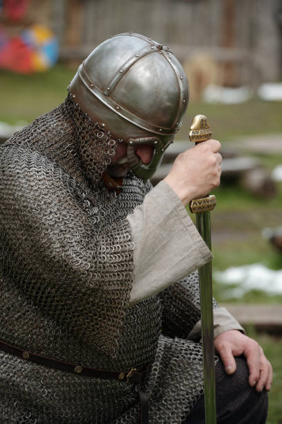 istock Bowing Medieval Knight in Chainmail Armor Holding Sword 2177650738