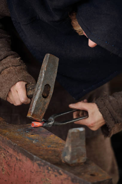 istock Blacksmith Forging Red-Hot Metal on Anvil with Hammer 2177650739