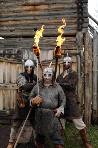 istock Holding Flaming Torches During Historical Reenactment at Wooden Structure 2177650755