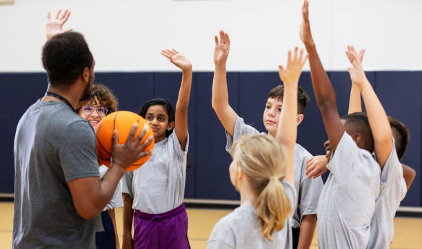 istock Elementary students in school gym playing basketball 2177650894