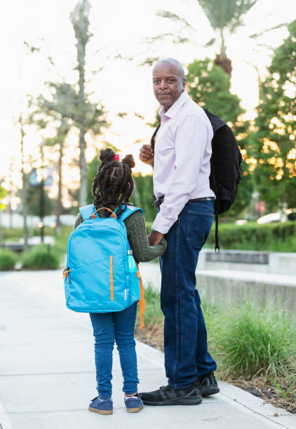 istock African-American father walks daughter to school 2177650926