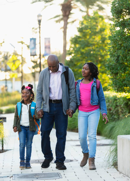 istock African-American father taking daughters to school 2177650997
