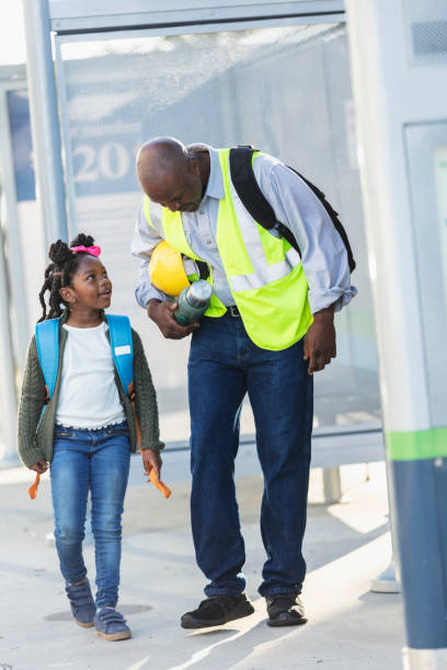 istock Father takes daughter to school before work in city 2177651027