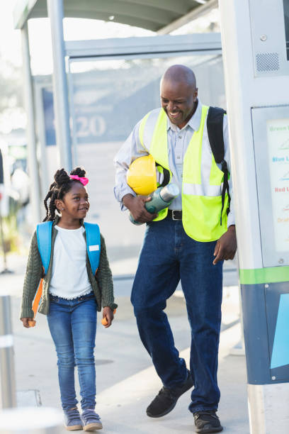 istock Father takes daughter to school before work in city 2177651034
