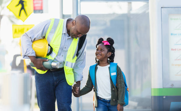 istock Father takes daughter to school before work in city 2177651040