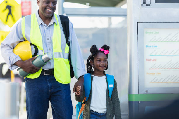 istock Father takes daughter to school before work in city 2177651041