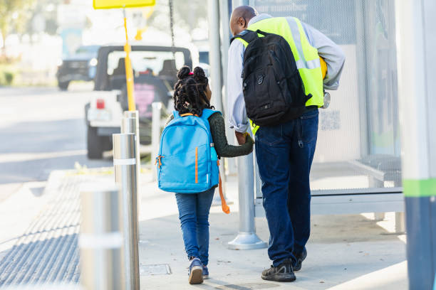 istock Father takes daughter to school before work in city 2177651043