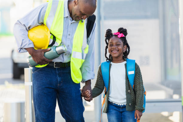 istock Father takes daughter to school, holding hands 2177651046