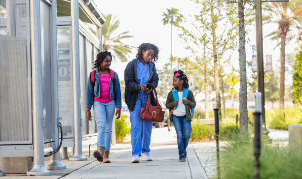 istock African-American working mother takes daughters to school 2177651083