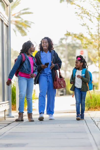 istock African-American working mother takes daughters to school 2177651084