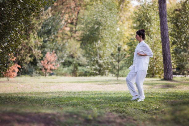 istock Women practicing Qi Gong in the nature alone 2177652541