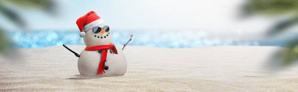 istock snowman with sunglasses on sunny beach - beach christmas concept 2177657077
