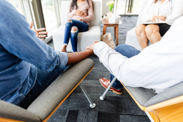 istock Adoptive couple holds hands while talking to pregnant woman 2177657245