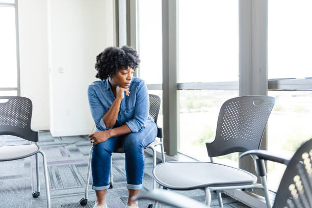 istock Resting head on hand, depressed woman looks out window 2177657262