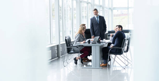istock Mature businessman discussing with colleagues in board room. 2177657452