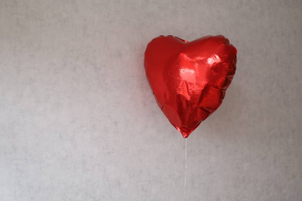 Low Angle View Of Heart Shape Balloon In Sky