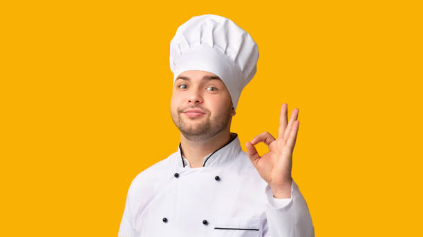 istock Male Chef Gesturing OK Over Yellow Studio Background, Panorama 2177661582