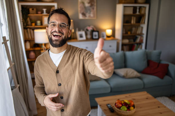 istock A young man with a smile, shows 'like' to the camera 2177662298