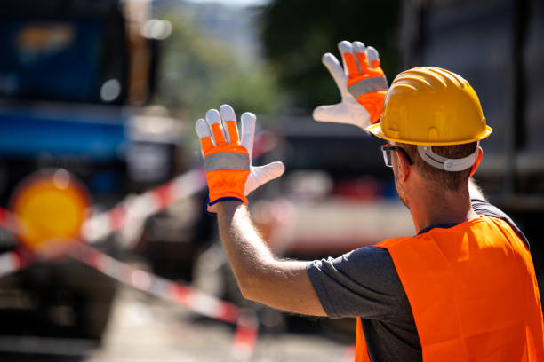 istock Construction worker directing traffic near work zone during bright sunny day, ensuring safety on busy road 2177663396