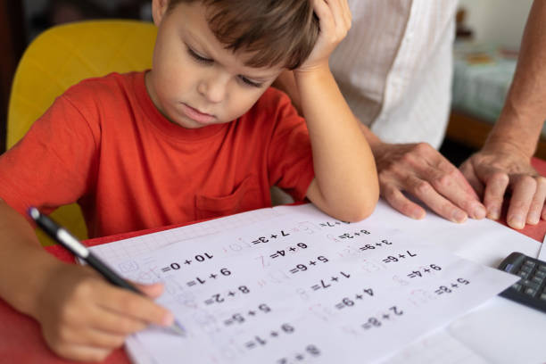 istock A boy with dyscalculia and dysgraphia tries to complete his math homework. 2177663591