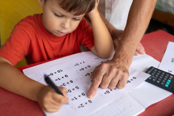 istock A boy with dyscalculia and dysgraphia tries to complete his math homework. 2177663604