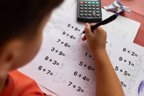 istock Over the shoulder view of a child who has dyslexia and dyscalculia doing math homework. 2177663614
