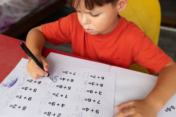 istock A boy with dyscalculia and dysgraphia tries to complete his math homework. 2177663625