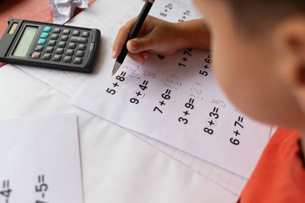 istock Over the shoulder view of a child who has dyslexia and dyscalculia doing math homework. 2177663626