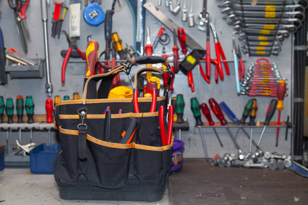 An electrician's bag full of tools stands in the workshop.