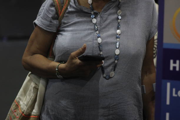 Macoya, Trinidad & Tobago - Sept 13, 2024: An elderly woman looking at a message on her smart phone