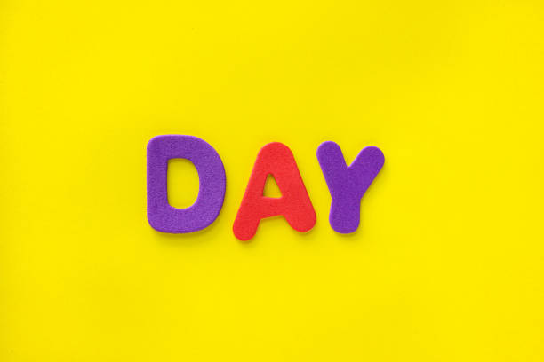 istock Colorful Day text letters isolated on yellow background with copy space. 2177666838