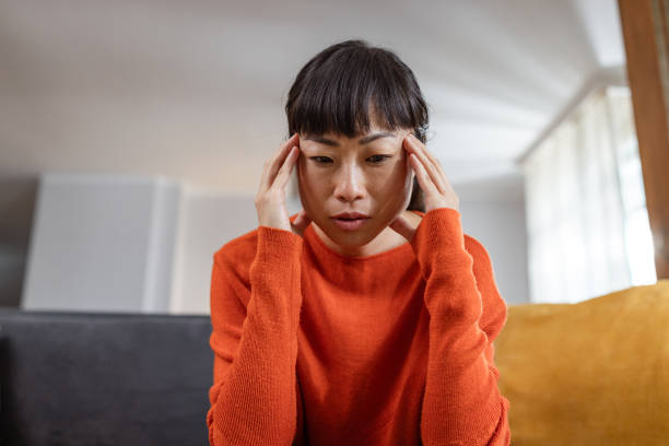 Despair Japanese woman having a headache