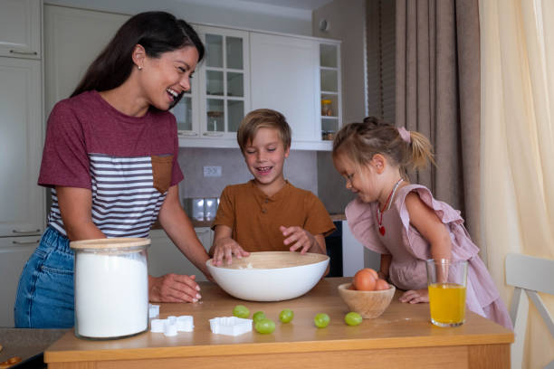 istock family making dough at the table, looking at each other and laughing 2177669652