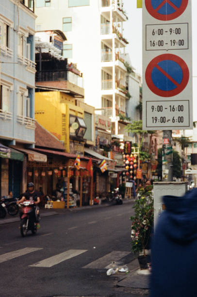 Vietnamese Flag at Old Quarter in Hoan Kiem District in Hanoi, Vietnam, with many shops and cafes visible.