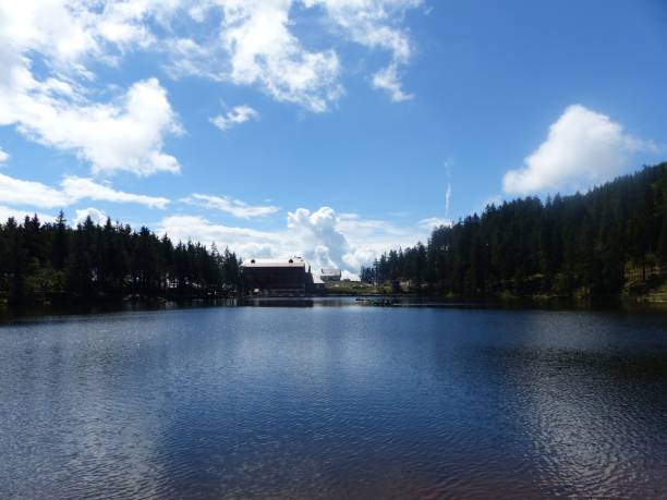 istock Sunny clear sky with white clouds over a forest with a house on Mummelsee Lake in Germany 2177671514