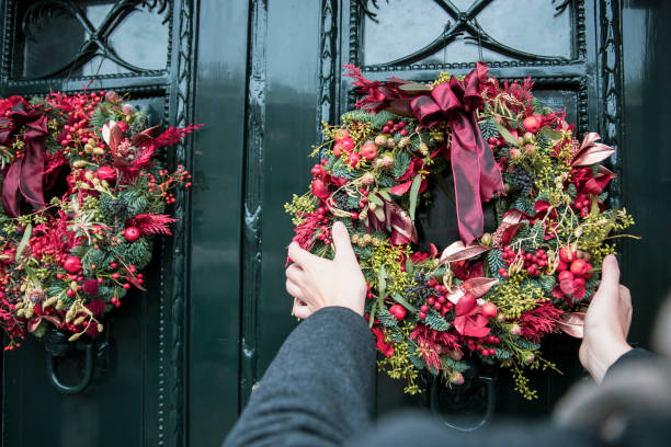 istock Man Decorating entrance door for Winter Holidays 2177672925