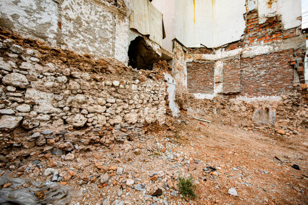 Worn out wall of old stone and brick house