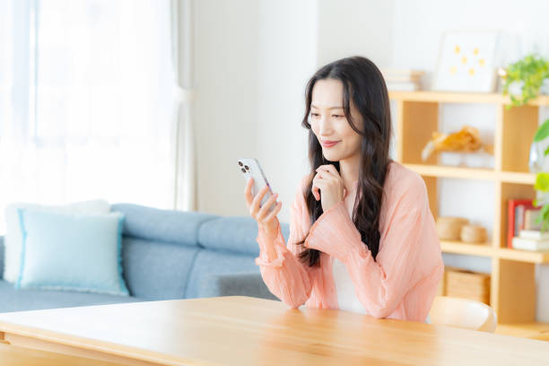 istock A woman operating a smartphone in the room 2177674100