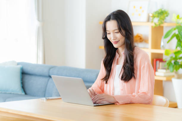 istock Woman operating a laptop at home 2177676441