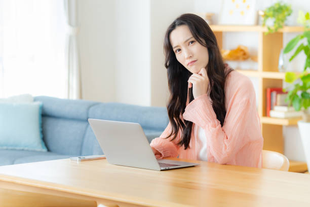 istock Woman operating a laptop at home 2177676460