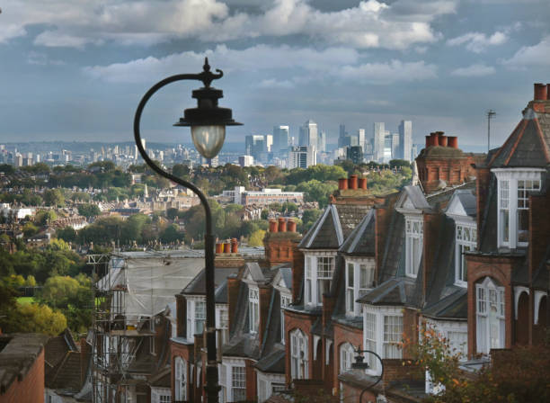 The rooftops of North London looking from Muswell Hill towards distant towers of Canary Wharf financial district