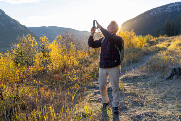 istock Mature man takes photo on mountain pathway 2177677758