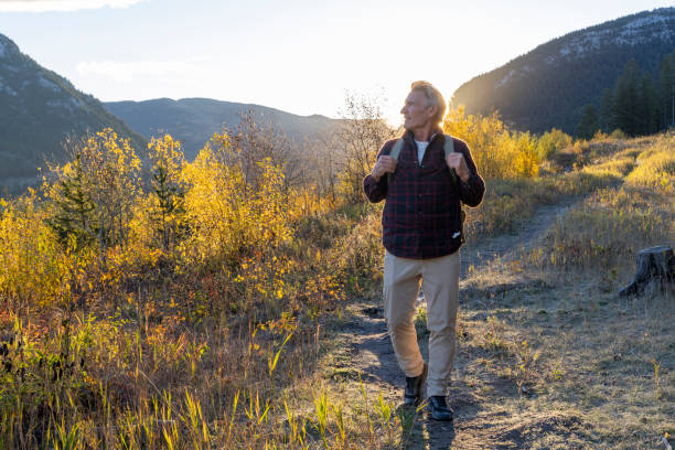 istock Mature man hikes along mountain path at sunrise 2177677761