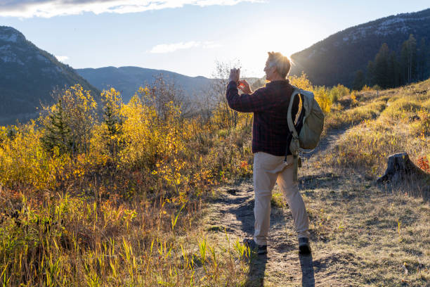 istock Mature man takes photo on mountain pathway 2177677763