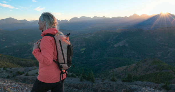 istock Mature woman hikes along mountain ridge 2177677771