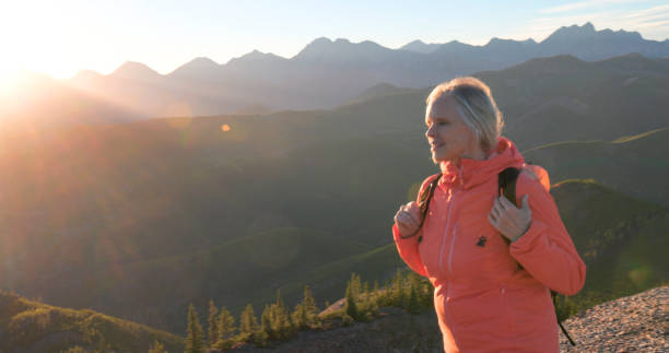 istock Mature woman hikes along mountain ridge 2177677786