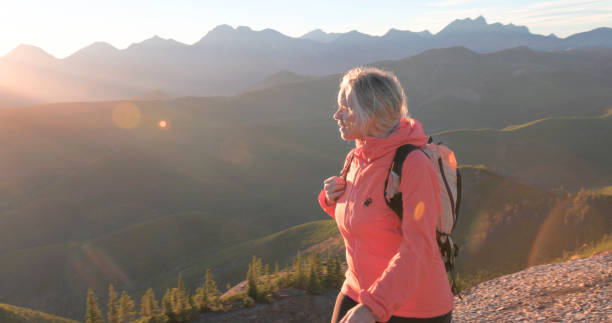 istock Mature woman hikes along mountain ridge 2177677790