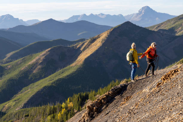 istock Mature mountain climber offers helping hand 2177677828
