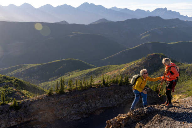 istock Mature mountain climber offers helping hand 2177677844