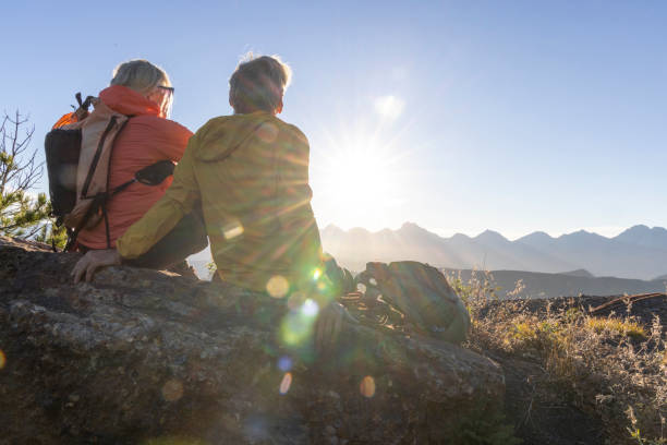 istock Mature couple sit on mountain top and  watch sunrise 2177677849